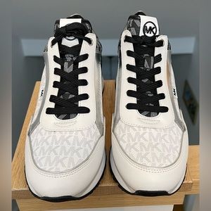 Michael Kors black, white, and chrome sneakers.